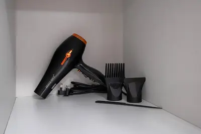 a black hair brush and a pair of boots at Newly Built Studio - Urban Living in Dubai