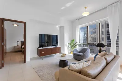 a living room with a couch and a table at Exquisite centrally located 1BR in Downtown Dubai in Dubai