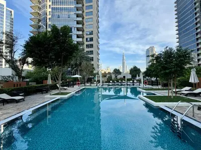 a large swimming pool in a city with tall buildings at Exquisite centrally located 1BR in Downtown Dubai in Dubai