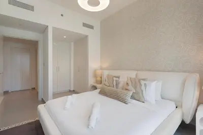 a white couch with pillows on it in a living room at Bright and Exquisite 1-Bedroom in Downtown views 2 in Dubai