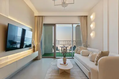 a living room with a couch and a flat screen tv at Bright and Exquisite 1-Bedroom in Downtown views 2 in Dubai