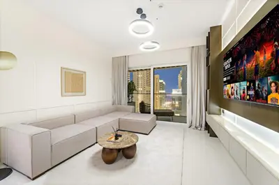a living room with a couch and a table at Elegant 2BR with Palm & Sea View l Direct Beach Access in Dubai