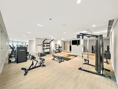 a gym with treadmills and cardio equipment in a building at Elegant 2BR with Palm & Sea View l Direct Beach Access in Dubai