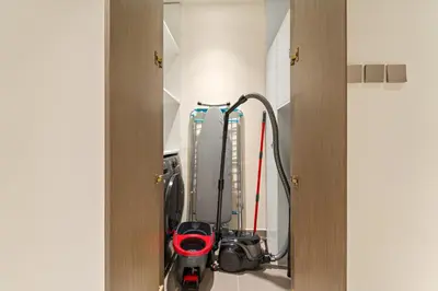 a room with a vacuum and a machine at Elegant 2BR with Palm & Sea View l Direct Beach Access in Dubai