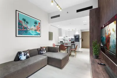 a living room with a couch and a tv at Full Dubai Skyline View LUX 1 BR JVC in Dubai
