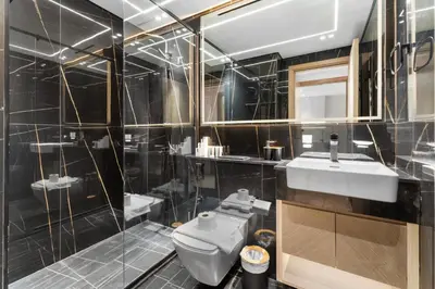 a bathroom with a white toilet and a sink at Full Dubai Skyline View LUX 1 BR JVC in Dubai
