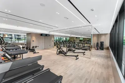a gym with a lot of treadmills and exercise bikes at Full Dubai Skyline View LUX 1 BR JVC in Dubai