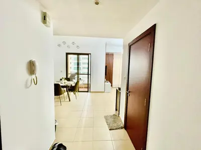 a hallway with a door leading to a dining room at Bahar 6 in Dubai