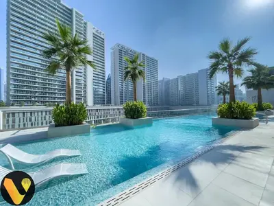 a swimming pool on the roof of a building with palm trees at Vogue Downtown The Sterling by Omniyat, near Burj Khalifa and Dubai Mall, Studio Apartment with Balcony and Access to all Amenities in Dubai