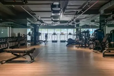 a gym with lots of treadmills and machines at Vogue Downtown The Sterling by Omniyat, near Burj Khalifa and Dubai Mall, Studio Apartment with Balcony and Access to all Amenities in Dubai