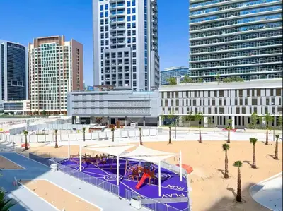 a playground in a city with tall buildings at Vogue Downtown The Sterling by Omniyat, near Burj Khalifa and Dubai Mall, Studio Apartment with Balcony and Access to all Amenities in Dubai