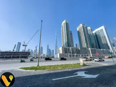 a city with tall buildings and a street with cars at Vogue Downtown The Sterling by Omniyat, near Burj Khalifa and Dubai Mall, Studio Apartment with Balcony and Access to all Amenities in Dubai