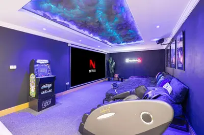 a room with a bed and a large screen at Next'Living - Luxury Private Room in a Shared Villa in Dubai