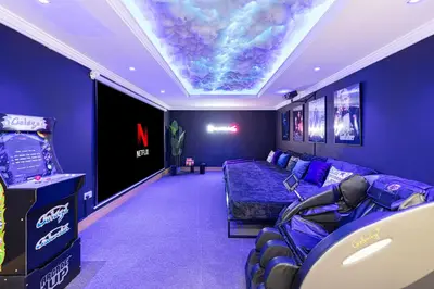 a room with a couch and a video game at Next'Living - Luxury Private Room in a Shared Villa in Dubai