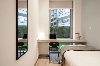 a bedroom with a desk with a laptop and a window at Next'Living - Luxury Private Room in a Shared Villa in Dubai