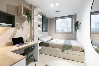 a bedroom with a bed and a desk with a laptop at Next'Living - Luxury Private Room in a Shared Villa in Dubai