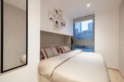 a bedroom with a bed and a large window at Next'Living - Luxury Private Room in a Shared Villa in Dubai