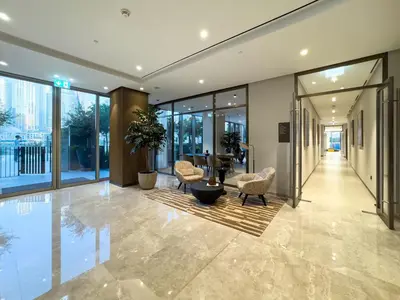 a lobby with chairs and a table in a building at 1 Bedroom apt High end luxurios building Next to Dubai mall in Dubai