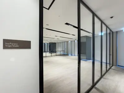 a hallway with glass doors in an office building at 1 Bedroom apt High end luxurios building Next to Dubai mall in Dubai
