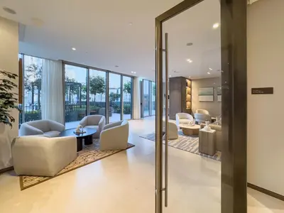 a lobby with chairs and tables and windows at 1 Bedroom apt High end luxurios building Next to Dubai mall in Dubai