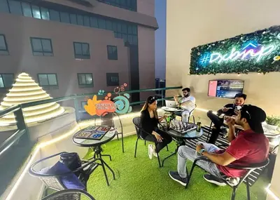 a group of people sitting in chairs in a building at The Junction Partition Room In Barsha Heights in Dubai