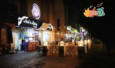 a restaurant with lights on a street at night at Rest Partition Room in Tecom Near Metro in Dubai