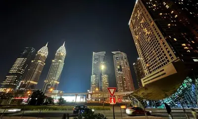 a group of tall buildings in a city at night at Rest Partition Room in Tecom Near Metro in Dubai