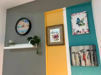 a room with a door and a clock on the wall at Creative Partition Room in Barsha 1 Near Metro in Dubai