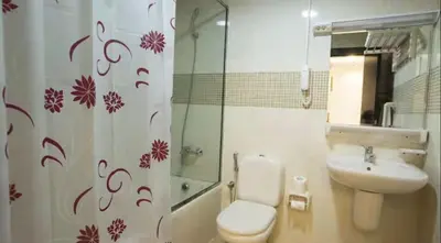 a bathroom with a toilet and a sink and a shower at Ideal Partition Room in Barsha 1 Near Metro in Dubai