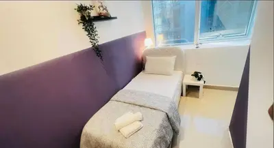 a small room with a couch and a window at Ideal Partition Room in Barsha 1 Near Metro in Dubai