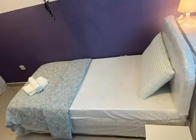 a bed with two towels on it in a room at Ideal Partition Room in Barsha 1 Near Metro in Dubai