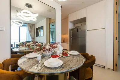 a kitchen and dining room with a table and chairs at Elegant 2BR Apt Address Beach Resort in Dubai