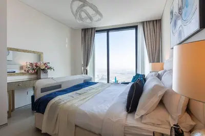 a bedroom with a large bed with a large window at Elegant 2BR Apt Address Beach Resort in Dubai