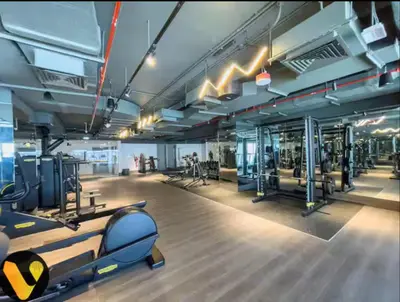 a gym with treadmills and machines in a building at Vogue Downtown The Sterling by Omniyat, near Burj Khalifa and Dubai Mall, Studio Apartment with Balcony and Access to all Amenities in Dubai