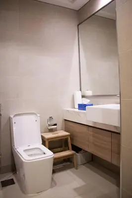 a bathroom with a toilet and a sink and a mirror at Modern Studio 15mins away From World Trade Center in Dubai