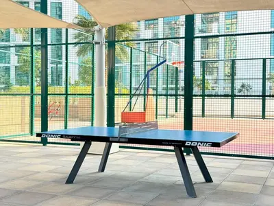 a blue ping pong table in front of a building at Modern Studio 15mins away From World Trade Center in Dubai