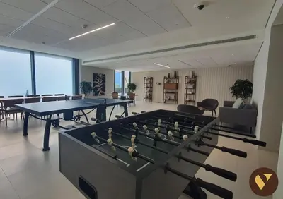 a room with two tables and ping pong tables at Vogue Downtown Boulevard Heights near Dubai Mall and Burj Khalifa, Two Bedroom Apartment with balcony and Access to all Amenities in Dubai