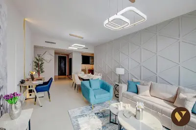 a living room with a couch and a table at Vogue Downtown Boulevard Heights near Dubai Mall and Burj Khalifa, Two Bedroom Apartment with balcony and Access to all Amenities in Dubai