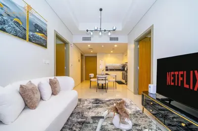 a living room with a white couch and a tv at CHIC Sea View 2Bhk 4pax in Dubai
