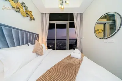 a bedroom with a bed with a large window at CHIC Sea View 2Bhk 4pax in Dubai