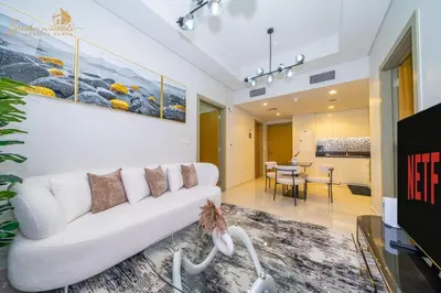 a living room with a white couch and a table at CHIC Sea View 2Bhk 4pax in Dubai