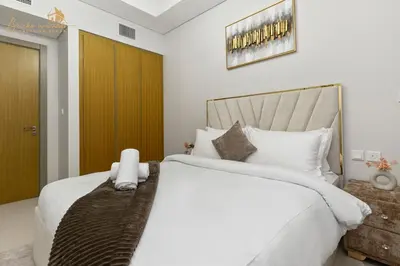 a bedroom with a large bed with white sheets at Exclusive Sea-View 3Bhk 6pax in Dubai