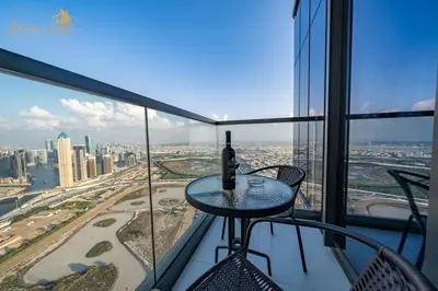 a table with a bottle of wine on top of a building at Exclusive Sea-View 3Bhk 6pax in Dubai