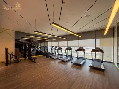 a gym with a row of treadmills in a building at Exclusive Sea-View 3Bhk 6pax in Dubai