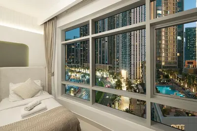 a bedroom with a window with a view of a city at Beautiful 2 BR Apartment next to Opera I Burj View in Dubai