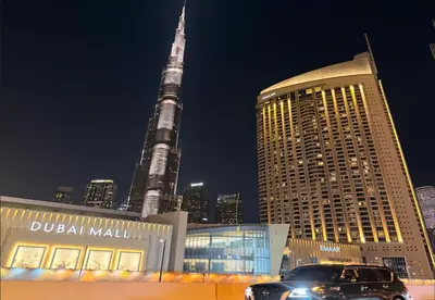 a car parked in front of dubai mall with the tallest building at Kempinski Central Avenue Residence 1BR- Direct access to Dubai Mall in Dubai