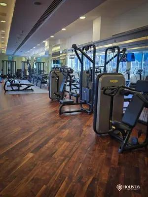 a gym with rows of treadmills and elliptical machines at Kempinski Central Avenue Residence 1BR- Direct access to Dubai Mall in Dubai