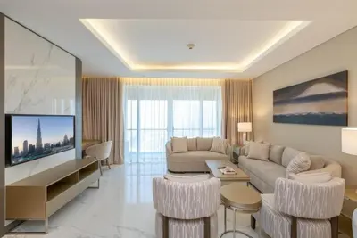 a living room with a couch and a tv at Kempinski Central Avenue Residence 1BR- Direct access to Dubai Mall in Dubai