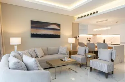 a living room with a couch and chairs and a table at Kempinski Central Avenue Residence 1BR- Direct access to Dubai Mall in Dubai