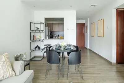 a dining room and living room with a table and chairs at Frank Porter - Marina Park in Dubai